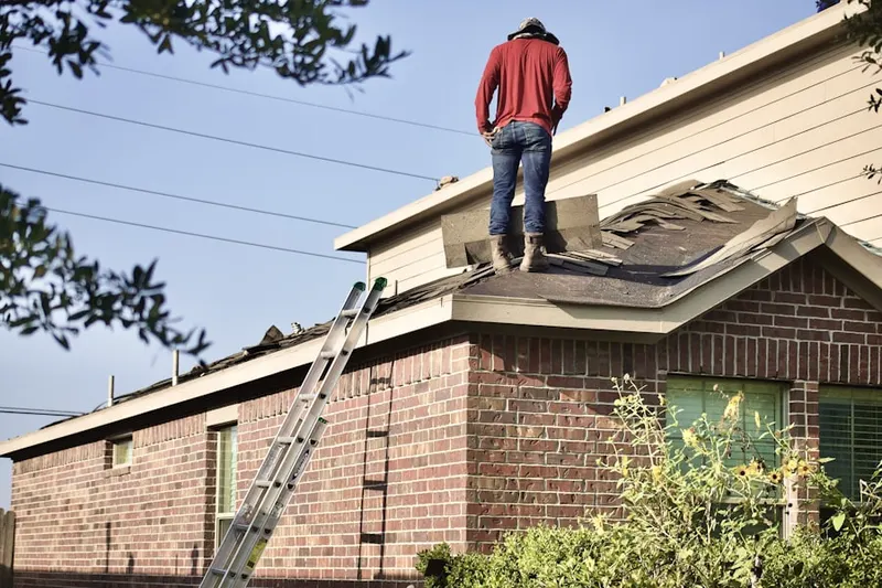 Professional roofer working on a residential roof in Hickory Bluff